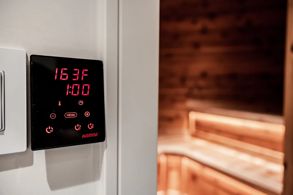 Sauna control panel reading 163°F with a one-hour timer